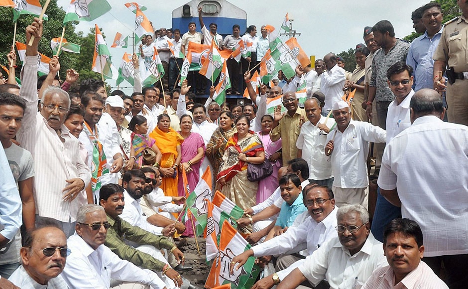Congress activists protest against rail fare hike on the railway tracks, in Kolhapur,Maharashtra on Wednesday. PTI