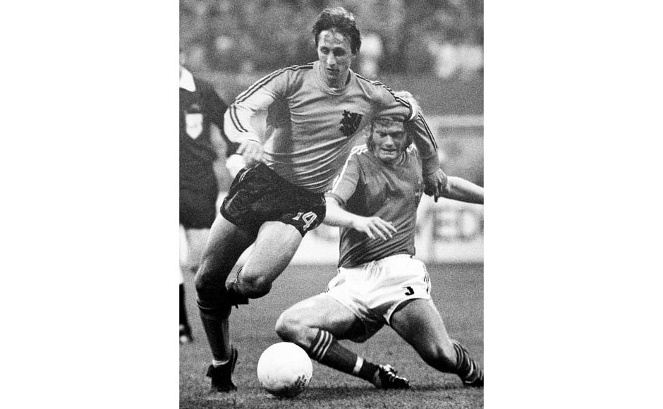 In This June 19, 1974 file photo, Netherlands Johan Cruyff, left, dodges the tackle from Sweden's Kent Karlsson during a World Cup soccer match in Dortmund, Germany. Cruyff never won a World Cup, never was top scorer and played only one final tournament. Yet it was more than enough to turn Johan Cruyff into a World Cup great because less than a handful of the game's greatest stars combined beauty, speed, vision and elegance like he did. At the 1974 World Cup in West Germany, Cruyff led Oranje with guile and cockiness as the Netherlands beat teams like Uruguay, Argentina and Brazil with free-flowing 