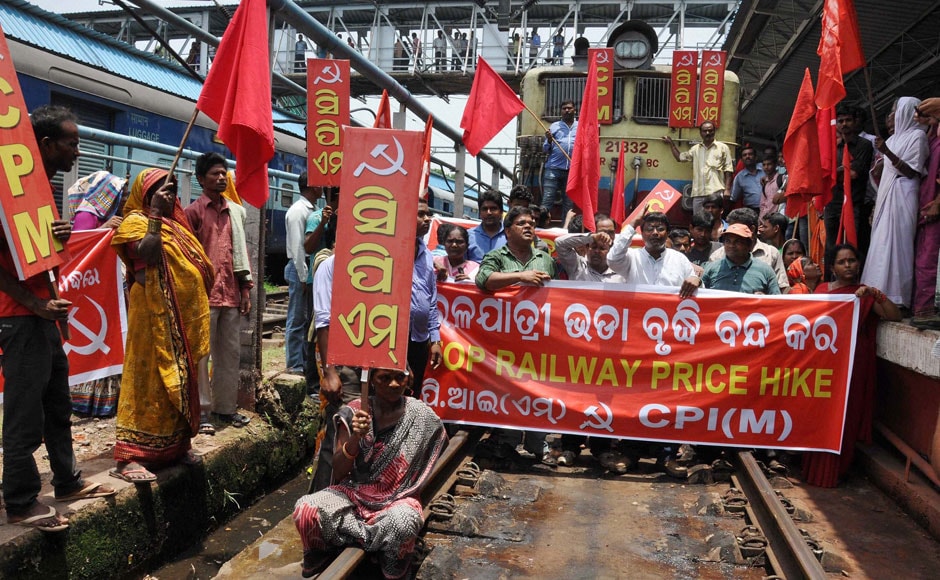 CPI(M) activists stop the train protesting against train fare hike at railway station in Bhubaneswar on Wednesday.PTI