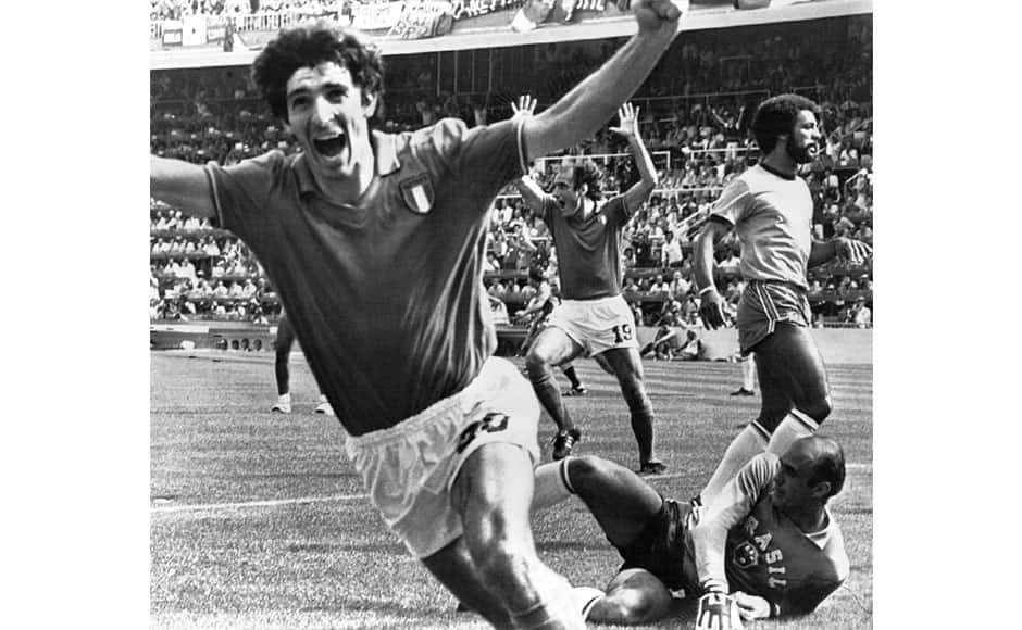  In this July 5, 1982 file photo, Italy's Paolo Rossi, left, celebrates, after scoring the second goal for his team during their World Cup match second round soccer match against Brazil, in Barcelona, Spain. Brazilian goalkeeper Valdir Perez, lies on pitch as defender Junior runs at right. On this day: Italy beats Brazil 3-2 in a classic World Cup match to progress to the semifinals. AP