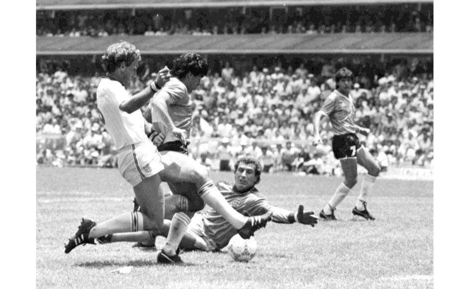 In this June 22, 1986 file photo, Argentina's Diego Maradona, second left, is about to score his second goal against England, during their World Cup quarter final soccer match, in Mexico City, Mexico. England's Terry Butcher, left, tries to tackle Maradona, while England's goalkeeper Peter Shilton is on the ground. On this day: Maradona scores what many consider to be the greatest individual goal scored in World Cup history, helping Argentina see off England 2-1. AP