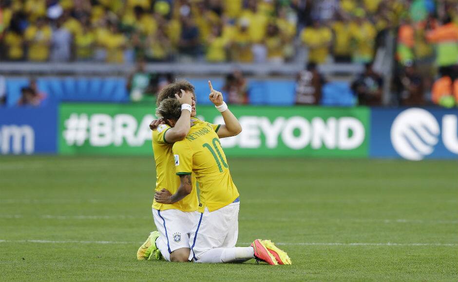 Brazil’s Neymar hugs teammate David Luiz after a penalty shootout following regulation time. Associated Press 