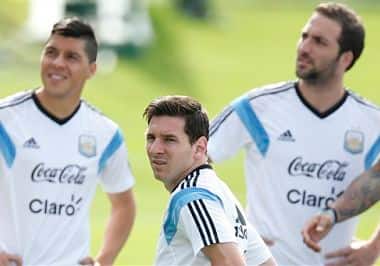 Argentina's Lionel Messi, center, stands with teammates Enzo Perez, left, and Gonzalo Higuain. AP