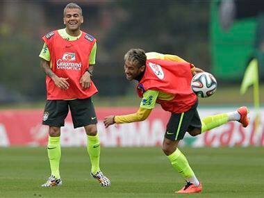Brazil's Neymar, right, and Dani Alves, practice during a training session. AP