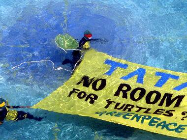 Greenpeace activists putting up a banner in the Taj Lands End hotel swimming pool in this  file photo. Reuters