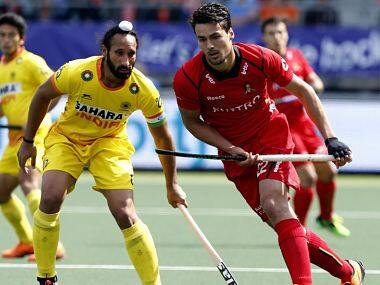 Belgium's Simon Gougnard (R) fights for the ball with India's Sardar Singh during the Field Hockey World Cup 2014 men's group stage match between Belgium and India at The Hague, Netherlands. AFP