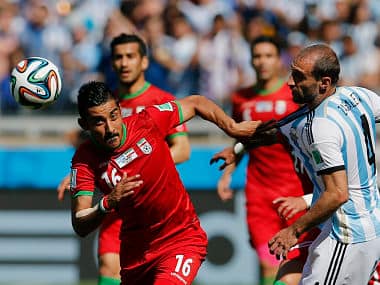 Iran's Reza Ghoochannejhad (L) pulls the shirt of Argentina's Pablo Zabaleta during their 2014 World Cup Group F match. Reuters
