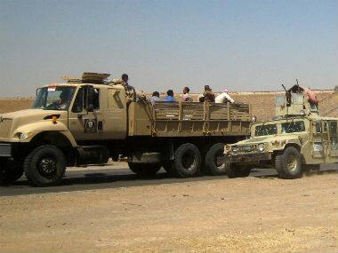 Iraqi security forces in uniforms and plainclothes head to Baghdad in the main road between Baghdad and Mosul, a day after fighters from the Islamic State of Iraq and the Levant took control of much of Mosul. AP 