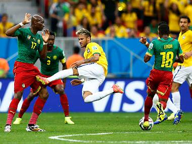 Brazil's Neymar (C) fights for the ball with Cameroon's Enoh Eyong (18) and Stephane Mbia (L). Reuters 