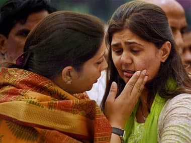 Gopinath Munde's daughter Pankaja with Smriti Irani on Tuesday. PTI