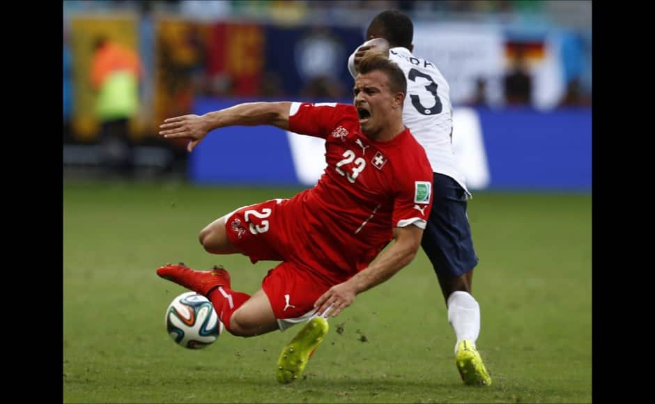 Switzerland's Xherdan Shaqiri (in red) is fouled by France's Patrice Evra. Reuters