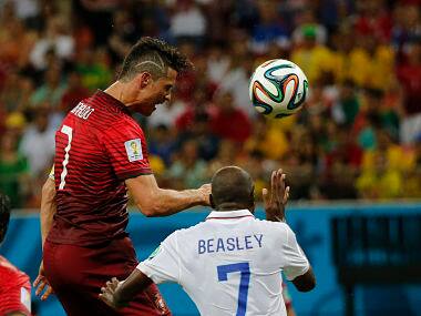 Portugal's Cristiano Ronaldo (L) fights for the ball with DaMarcus Beasley of the USA. Reuters