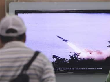 People watch a TV news program showing the missile launch conducted by North Korea, at Seoul Railway Station in Seoul, South Korea. AP
