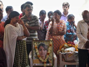Relatives and friends mourn next to a portrait of Gampala Aishwarya, one of the students who was swept away in a sudden dam release, during her funeral at her residence in Hyderabad. AP 