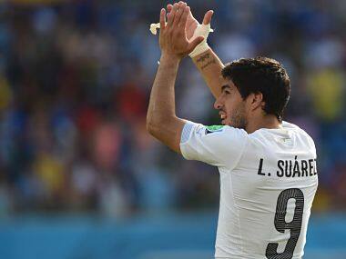 Uruguay's forward Luis Suarez celebrates their victory at the end of a Group D football match between Italy and Uruguay. AFP