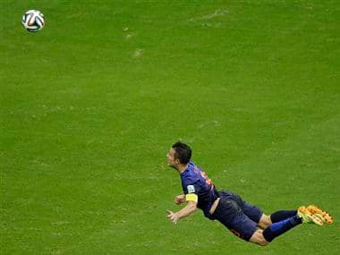 Netherlands' Robin van Persie heads the ball to score during the group B World Cup soccer match between Spain and the Netherlands. AP