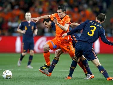 Netherlands' Robin van Persie fights for the ball with Spain's Gerard Pique and teammate Sergio Busquets during their 2010 World Cup final soccer match at Soccer City stadium in Johannesburg. Reuters