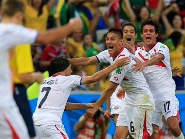 Costa Rica's Oscar Duarte, center, celebrates after scoring his side's second goal. AP