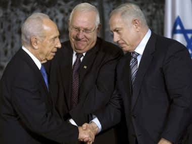 Israeli President Shimon Peres (left) greets Israeli Prime Minister Benjamin Netanyahu (right) as Knesset speaker Reuven Rivlin stands near. AP