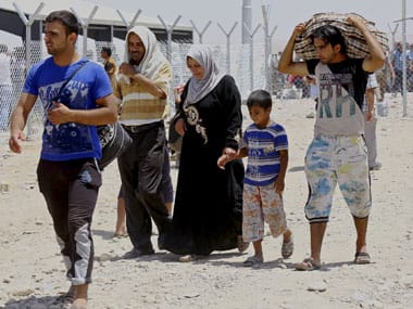 Refugees flee from Mosul, which was overrun by insurgents. AP