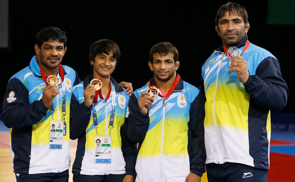 India's wrestling medalists Sushil Kumar, left with gold, Vinesh, second left with gold, Amit Kumar Amit, second right with gold and Rajeev Tomar, right, with silver pose with their medals at the Scottish Exhibition Conference Centre during the Commonwealth Games 2014 in Glasgow, Scotland, Tuesday July 29, 2014. AP
