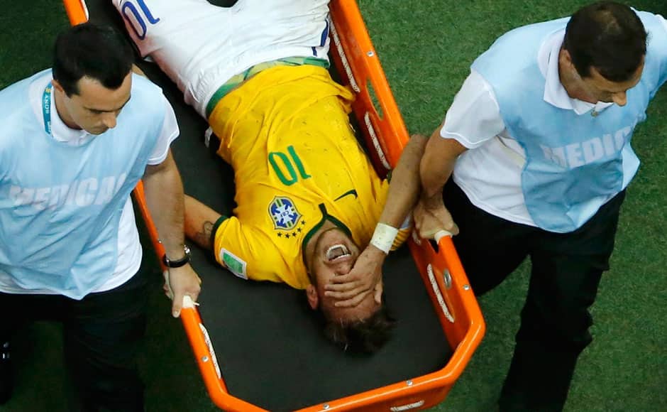 Brazil's chances in the World Cup took a big blow as Neymar was ruled out of the World Cup with a fractured vertebra. Neymar grimaces as he is carried off the pitch. Reuters