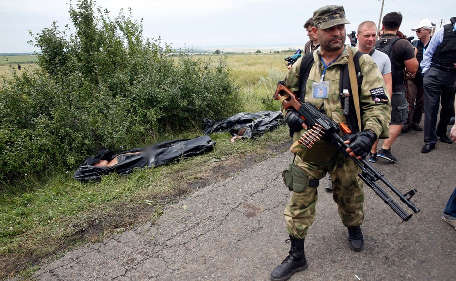 Photos: Ukraine Rebels Move MH17 Victim's Bodies, Tamper With Crash ...