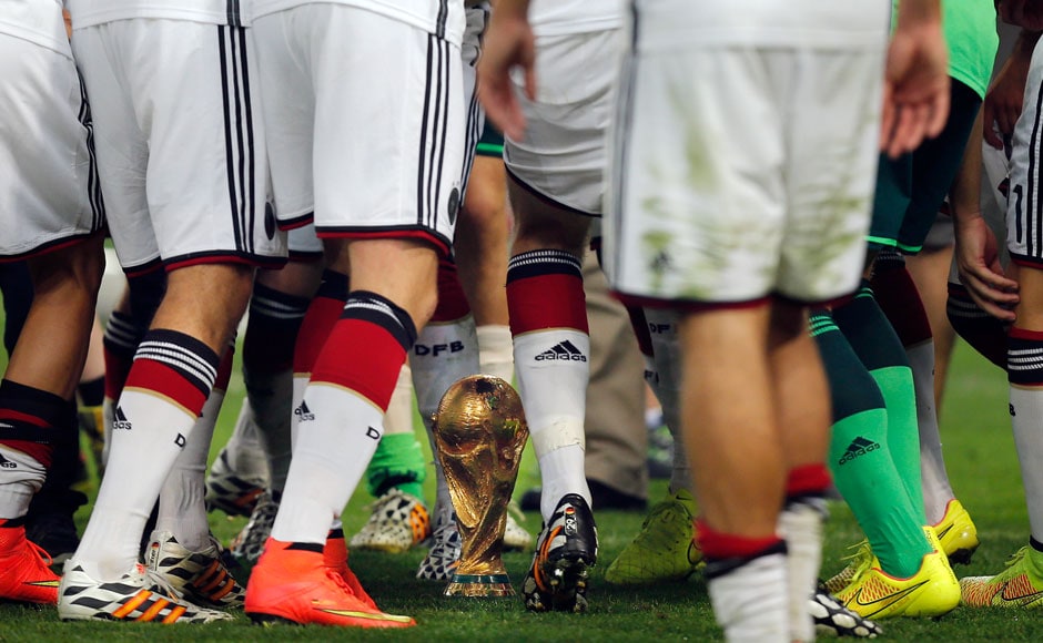 Germany's players dance around the trophy after the World Cup final soccer match between Germany and Argentina at the Maracana Stadium in Rio de Janeiro, Brazil, Sunday, July 13, 2014. Germany beat Argentina 1-0 to win its fourth World Cup title. AP