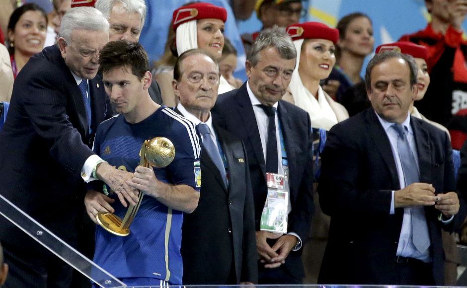 A dazed Lionel Messi walks away after receiving the Golden Ball trophy following Germany's 1-0 victory over Argentina. Associated Press.