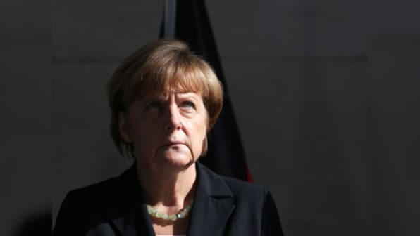 Merkel urges Putin to stop sending arms, fighters into Ukraine