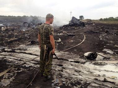 An armed pro-Russian separatist guard stands at the crash site. Reuters