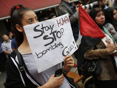 Demonstrators hold flags and placards during a Muslim protest against the Israeli assault on the Gaza Strip. Reuters