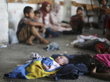 Palestinian children sleep as they stay inside a classroom at a United Nations-run school in Rafah in the southern Gaza Strip. Reuters image