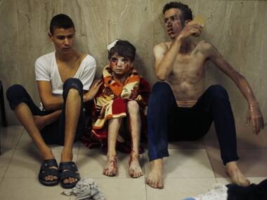 Two Palestinians, who medics said were wounded in Israeli shelling, sit at a hospital in Gaza City. Reuters Image
