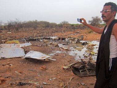 A man at the site of the Air Algerie plane crash in Mali. AP