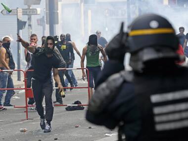 A pro-Palestinian protester throws a bottle at police during a demonstration against violence in Gaza, in Paris. Reuters image