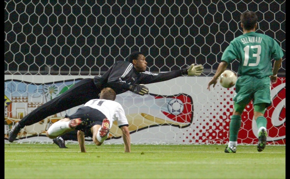 Germany's Miroslav Klose (front) scores the first goal as Saudi Arabia's goalkeeper Mohammed al Deayea dives and Saudi Arabia's Hussein Sulimani (R) looks on during their group E match World Cup Finals in Sapporo June 1, 2002. Reuters