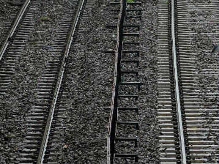 Woman falls onto railway track and dies, while two boys take pictures on their phones