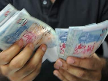 Singapore currency notes are seen in this file photo. AFP 