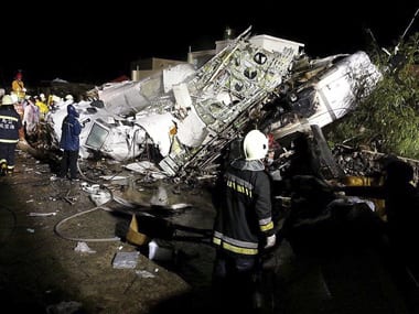 Rescue personnel survey the wreckage of TransAsia Airways flight GE222 on Taiwan's offshore island of Penghu. Reuters image