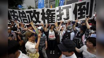 Japan takes historic step from post-war pacifism, OKs fighting for allies