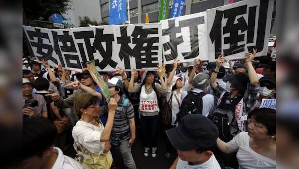 Japan takes historic step from post-war pacifism, OKs fighting for allies