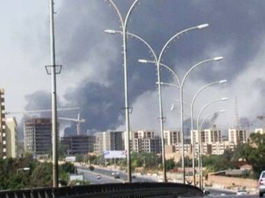Smoke rises from the direction of Tripoli airport in Tripoli, Libya. AP Image