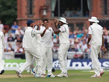 Bhuvneshwar Kumar, centre, celebrates with teammates after taking the wicket of England's Chris Jordan for 13 at Old Trafford cricket ground on the second day of the fourth test. AP 