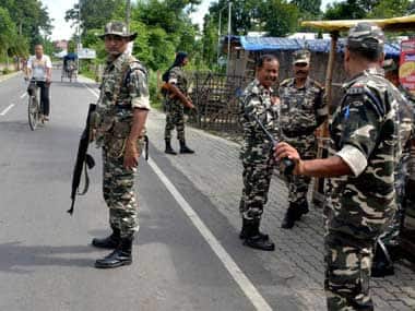 Security personnel patrol in the streets of tension-gripped Golaghat town after curfew was extended till 6PM on Friday. PTI 