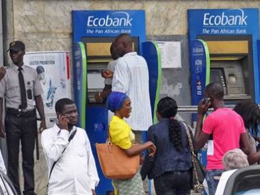 People queue outside a bank as fear spreads that some building’s dealing with the public might be closed due to the spread of the deadly Ebola virus, in the city of Monrovia, Liberia. AP