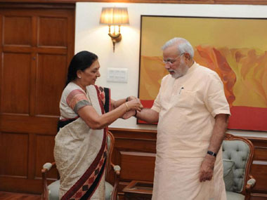 Gujarat CM Anandiben Patel ties rakhi on PM Modi's wrist Gujarat CM Anandiben Patel ties rakhi on PM Modi's wrist
