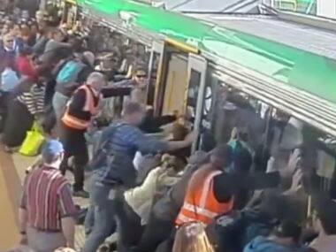 In Perth, Aussie commuters push train car to help free trapped man 
