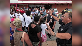 Cops use tear gas to disperse rioteers after killing of black Missouri teen