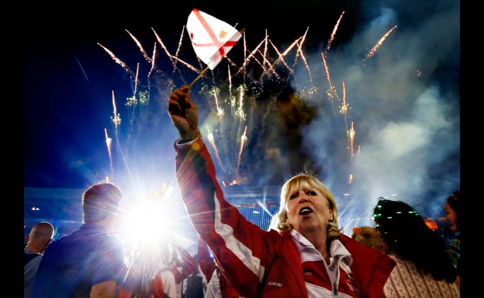 A woman waves a flag during the closing ceremony of the 2014 commonwealth games at Hampden Park in Glasgow, Scotland August 3, 2014. REUTERS